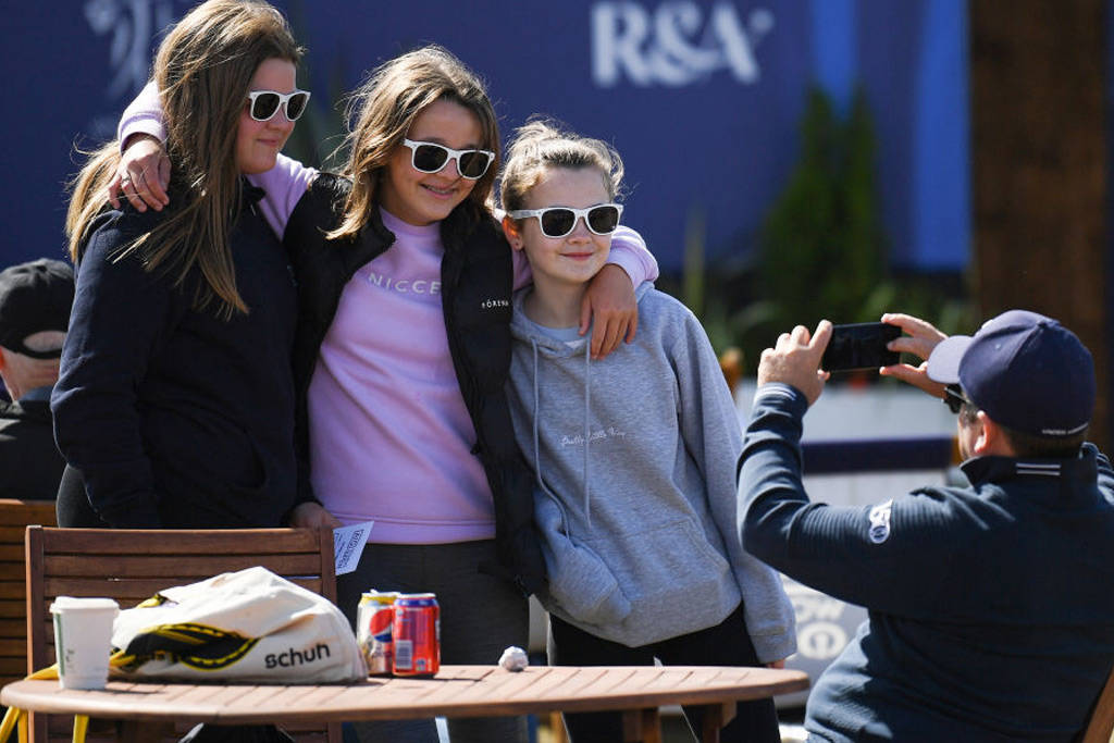 Friends posing for a photo in the fan village